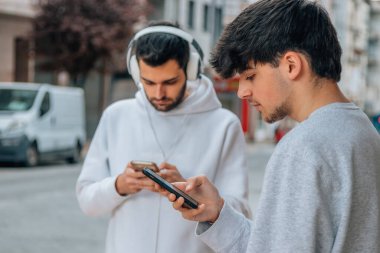 young people in the street with mobile phone