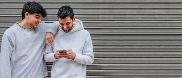 young people with mobile phone in the street