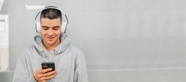 Joven Con Auriculares Teléfono Móvil —  Fotos de Stock