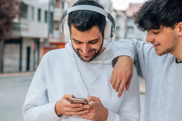 young people in the street with mobile phone