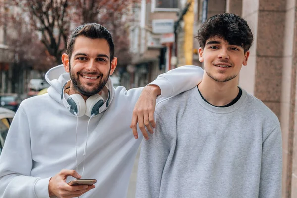 young people with mobile phone in the street