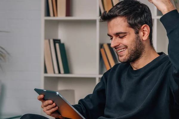 Hombre Casa Celebrando Emocionado Mirando Tableta Digital — Foto de Stock