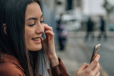 girl on the street looking at the mobile phone