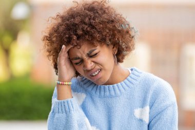girl in the street with a headache or stress