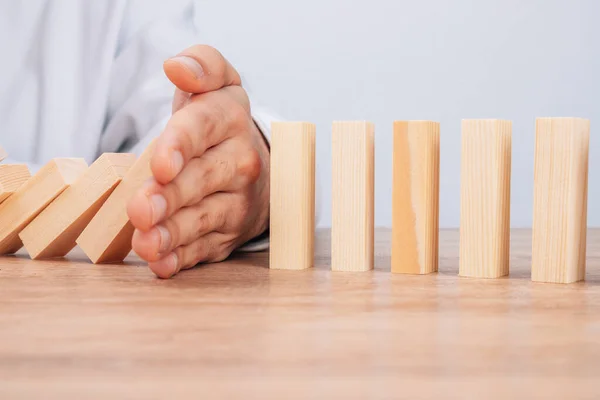 Hand Stops Falling Dominoes Wooden Puzzle — 스톡 사진