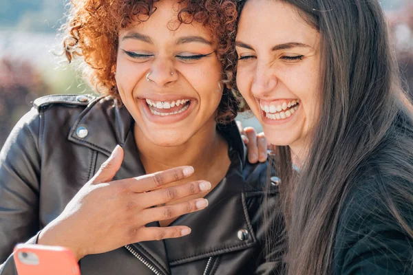 Smiling Girls Looking Mobile Phone Street — Stock fotografie