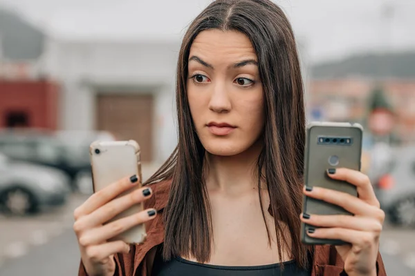 Girl Looking Mobile Phones Expression Doubt Surprise — Stock Fotó