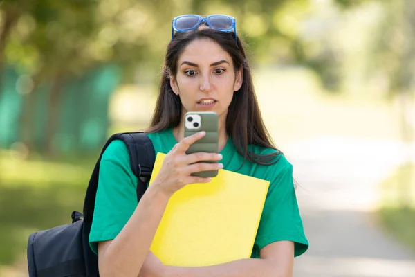 Surprised Student Looking Mobile Phone — Zdjęcie stockowe