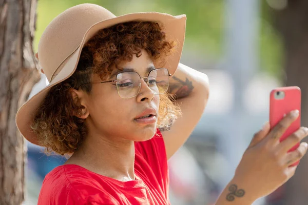 African American Girl Hat Glasses Looking Mobile Phone — Stock Fotó