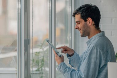 man at home with digital tablet or laptop