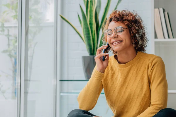 woman or girl at home talking on mobile phone