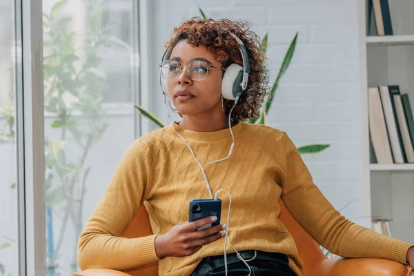 African American Girl Home Mobile Phone Headphones Listening Music — ストック写真