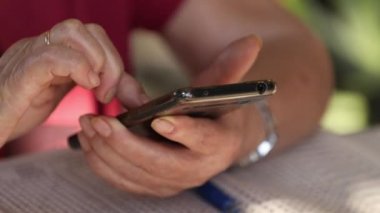 close-up hands typing on smartphone or cell phone
