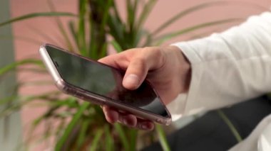 close-up hands typing on smartphone or cell phone