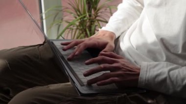 close-up hands typing on laptop or computer keyboard