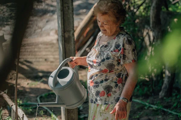 Senior Woman Summer Watering Vegetable Garden Watering Can — стоковое фото