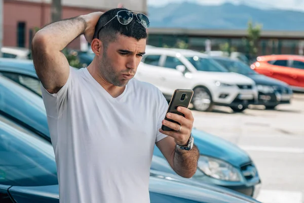 Mężczyzna Zakup Samochodu Patrząc Telefon Komórkowy Zaskoczony Lub Przerażony — Zdjęcie stockowe