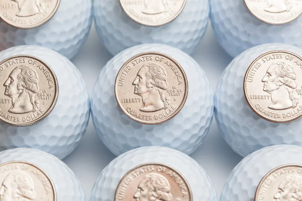 Golf balls and coins — Stock Photo, Image