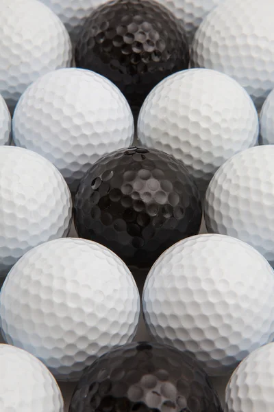 Bolas de golfe brancas e pretas e camisetas de madeira — Fotografia de Stock