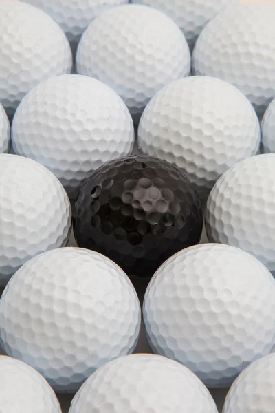 White and black golf balls in the box — Stock Photo, Image