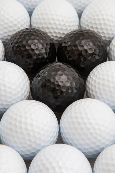 White and black golf balls in the box — Stock Photo, Image