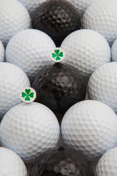 White and black golf balls and wooden tees — Stock Photo, Image