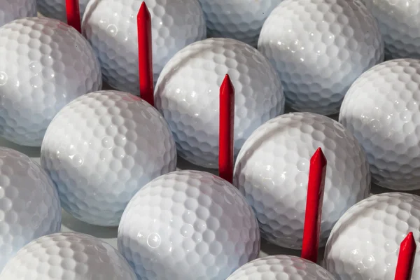 Golf balls and wooden tees in open box — Stock Photo, Image