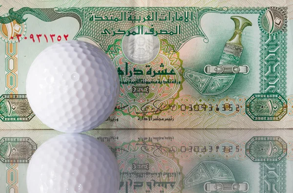Dirhams and golf ball — Stock Photo, Image