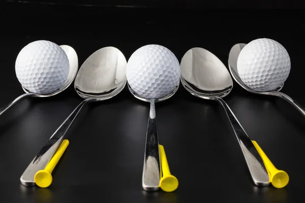 Spoons and golf balls — Stock Photo, Image