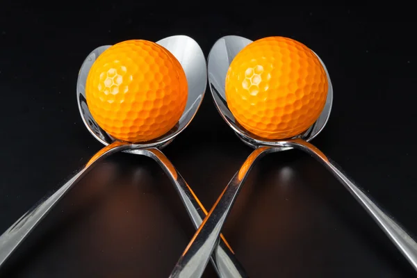 Sponns och golf bollar — Stockfoto