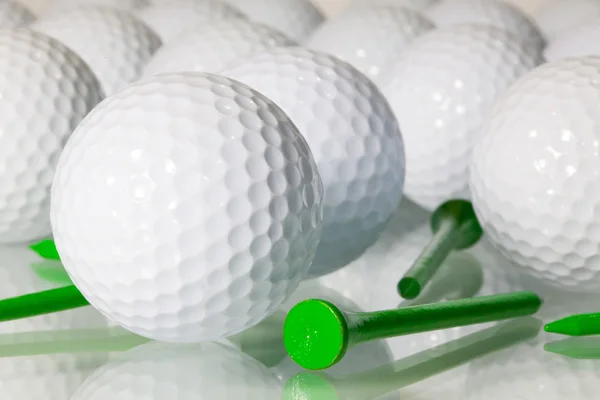 Muitas bolas de golfe em uma mesa de vidro — Fotografia de Stock