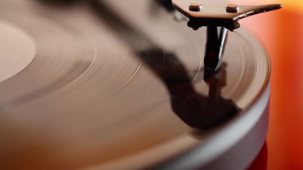 Two wedding rings lying on playing phonograph record — Stock Video