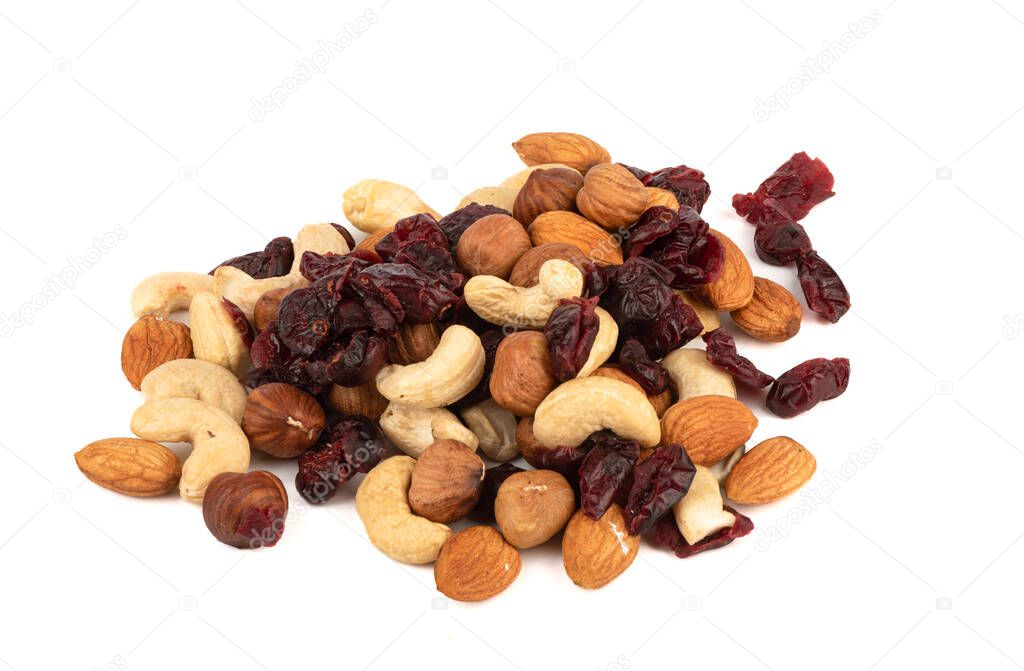 A mixture of almonds, hazelnuts, cashews and cranberries on a white background. Copy space.
