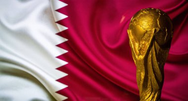 October 6, 2021 Doha, Qatar. FIFA World Cup Cup against the background of the Qatar flag. clipart