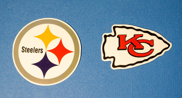 January 14, 2022. Kansas City, Missouri. The emblems of the football clubs of the playoffs of the National Football League season 2021/2022 Kansas City Chiefs and Pittsburgh Steelers on a blue background.