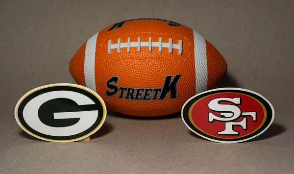 stock image January 18, 2022. Green Bay, Wisconsin. The emblems of the football clubs of the playoffs of the National Football League season 2021/2022 San Francisco 49ers and Green Bay Packers on a blue background.