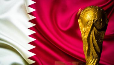 October 6, 2021 Doha, Qatar. FIFA World Cup Cup against the background of the Qatar flag. clipart