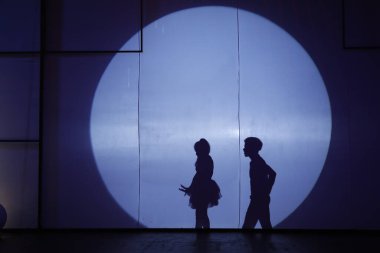 Dansçılar sahnede gölgeler.