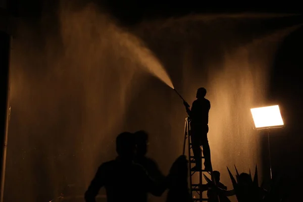 Silhouette Of Firefighter with Fire Hose Nozzle