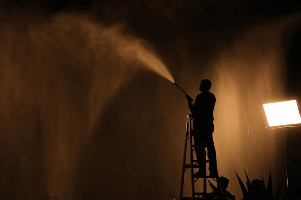 Silhouette Of Firefighter with Fire Hose Nozzle
