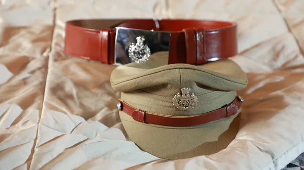 Indian Police Hat and Belt on the Bed