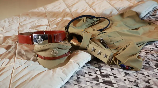 Indian Police Hat and Belt on the Bed