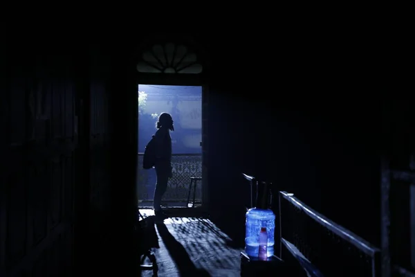 silhouette of man at Door