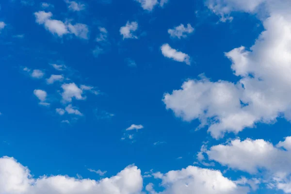 White and gray clouds in sun light on the blue sky perfect for the background. Landscape of beautiful blue sky with fluffy clouds