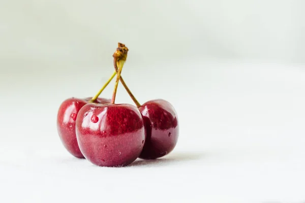 Three Juicy Berries Red Cherry Waterdrops White Fabric Background Few — Photo