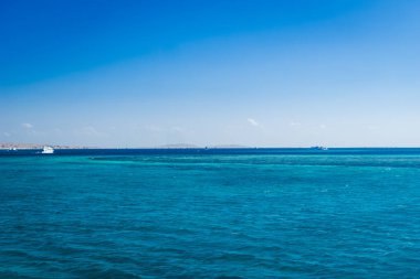 Beautiful seascape near Hurgada, Coast in Egypt Red Sea. Amazing nature background Luxury holiday resort. Boat on the horizon among the blue sea surface