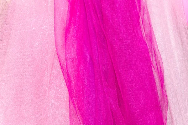 Texture chiffon fabric in shades of pink colors for backgrounds. Abstract pink chiffon with curve and wave. Light pink, bright pink and powder colors