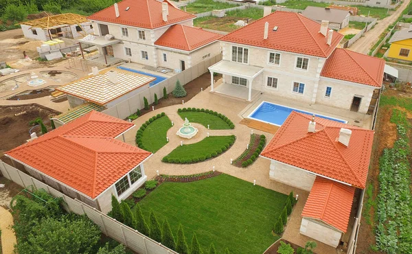 Top view of suburban house with pool, green garden and terrace. Large farm country house. High quality photo