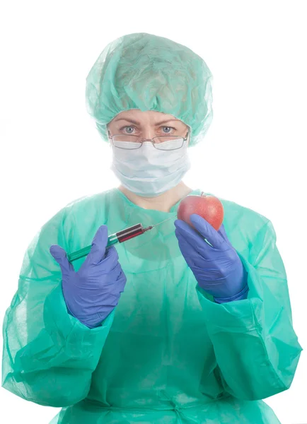 Doctor with syringe and apple — Stock Photo, Image