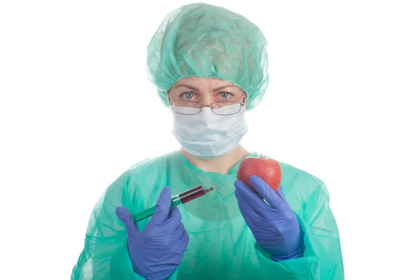 Doctor with syringe and apple — Stock Photo, Image